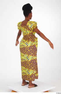 Dina Moses A poses dressed standing whole body yellow long…